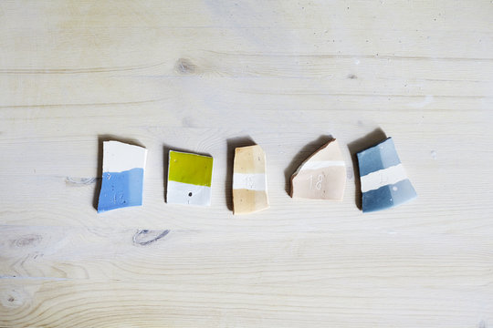Samples of colored enamel for ceramics, ceramic pieces, workshop in studio, hand-craft work