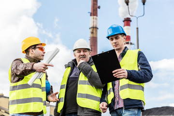 Construction engineers examining thermoelectric power station.