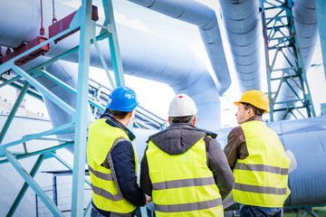 Engineers discussing maintenance of a petrochemical plant