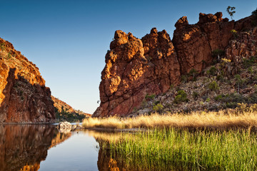 Reflections of rock formations at Glen Helen Gorge water hole