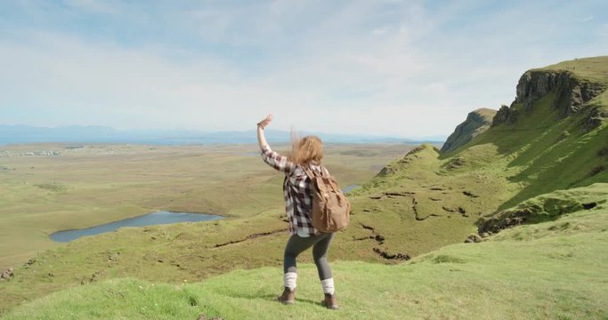 Woman dancing silly freestyle dance outdoors celebrating summer Crazy dancer girl having fun enjoying nature celebrating vacation travel adventure Quiraing Walk on the Isle of Skye in Scotland