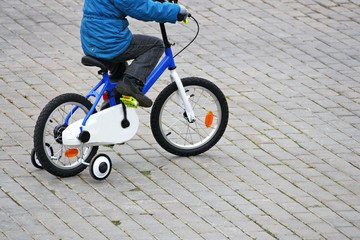 A boy rides on a bike.