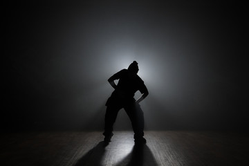 Hip-hop dancer backlit smoke