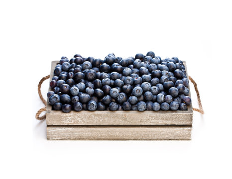 fresh  blueberries in a wooden box isolated on white background