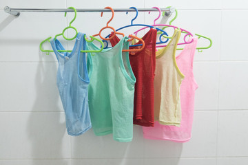 Clothes hanger with  sleeveless children's shirt