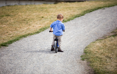 Toddler boy riding bike.