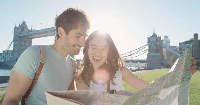 Tourist couple reading City Map planning European holiday Summer Vacation