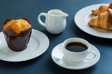 Breakfast. Coffee with milk muffin and croissants.
