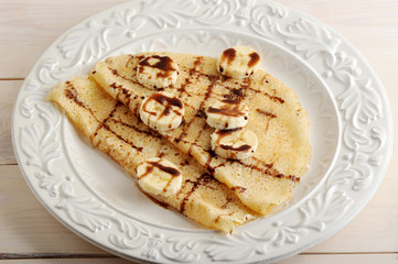 pancakes with banana and chocolate on a plate