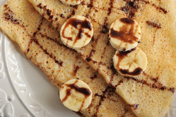 pancakes with banana and chocolate on a plate
