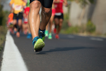 Marathon running race, runners feet on road