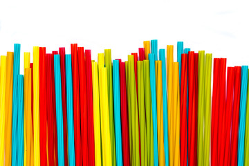 Pile of colorful straws isolated with white background.