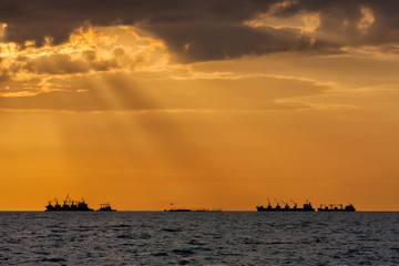 Obraz premium The cargo vessels are drop anchored in the sea waiting for the port.