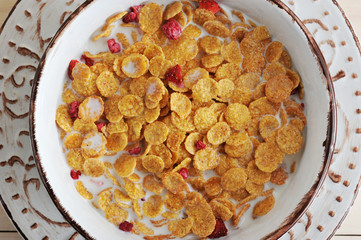 bowl of cereal and strawberries and milk close up