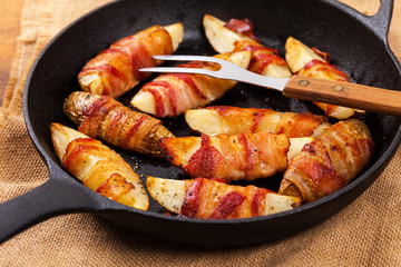 Bacon Wrapped Potatoes Wedges. Selective focus.