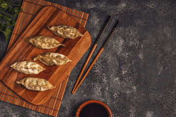 Fresh dumplings on a dark stone background.