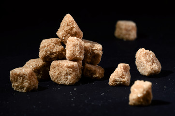 cane sugar on black background heap