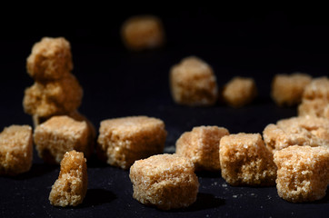 cane sugar on black background heap