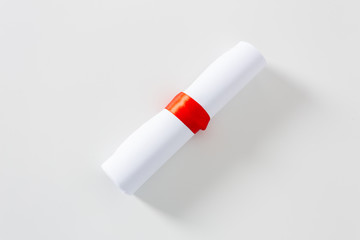 Diploma with red ribbon isolated