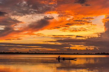 River view of sunset with fisherman