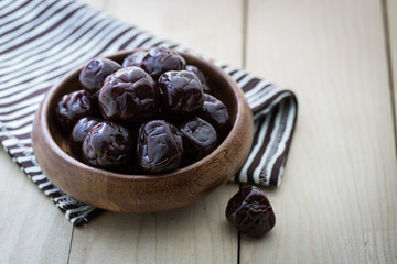 Dried plums on wood floor