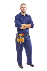 Portrait of a young worker standing with arms crossed on white background