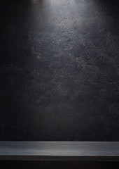 wooden shelf at black wall