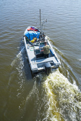 Fishing motor boat sailing in the lagoon of Comacchio, Italy (Valli di Comacchio)