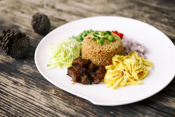 Asian food. Rice Seasoned With Shrimp Paste (Khaao Khlook Gabpi) on wooden background