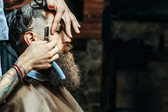 Bearded Man With Long Beard Getting Hair Shaving With Razor