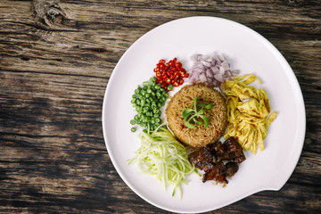 Asian food. Rice Seasoned With Shrimp Paste (Khaao Khlook Gabpi) on wooden background