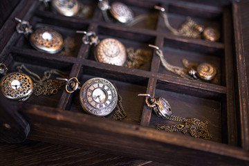 Many old pocket clock on wooden desk