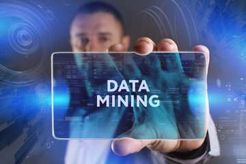 Business, Technology, Internet and network concept. Young businessman working on a virtual screen of the future and sees the inscription: Data mining