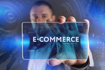 Fototapeta premium Business, Technology, Internet and network concept. Young businessman working on a virtual screen of the future and sees the inscription: E-commerce