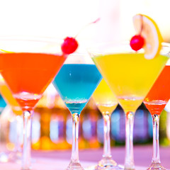 Group of colorful cocktail in martini glasses.