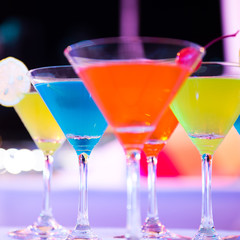 Group of colorful cocktail in martini glasses.