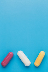 Three multi colored pills