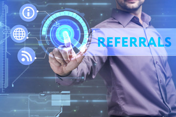 Business, Technology, Internet and network concept. Young businessman working on a virtual screen of the future and sees the inscription: Referrals
