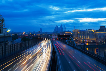 Movement of cars along the avenue in Moscow at dusk