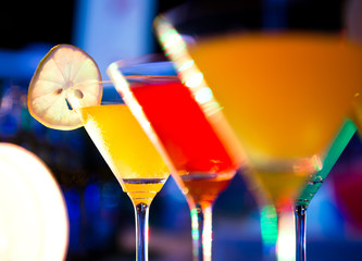 Group of colorful cocktail in martini glasses.