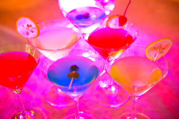 Group of colorful cocktail in martini glasses.