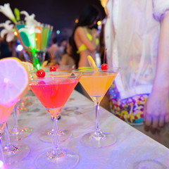 Group of colorful cocktail in martini glasses.