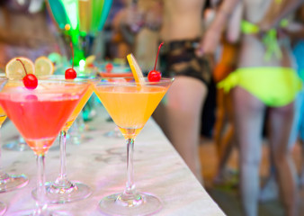 Group of colorful cocktail in martini glasses.