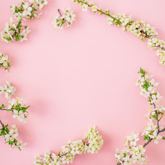 Floral frame of spring flowers on pink background. Flat lay, top view. Spring time background.