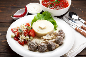 Business lunch. Soup and the second dish. Wooden table.