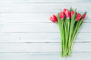 Red tulips over wooden background