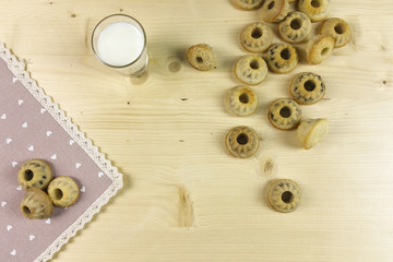Small donuts on wood background - top view