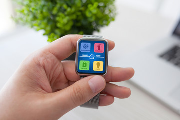 man hand holding watch with app smart home on screen