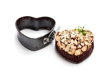 Valentines  day dessert. Heart shaped chocolate cake and metal form tin