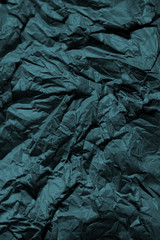 Dark green crumpled   paper background